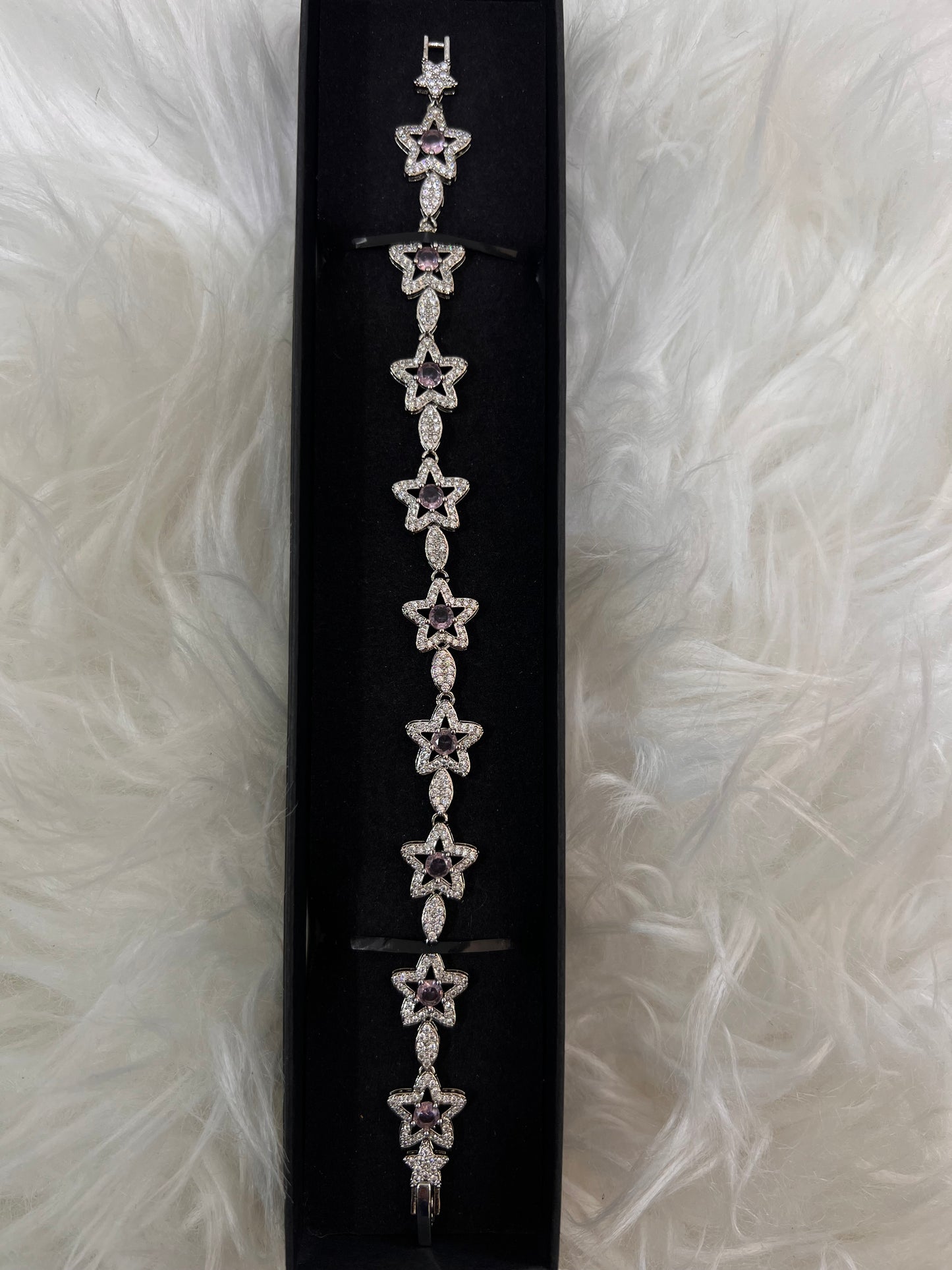 A silver-toned bracelet with repeating star motifs,