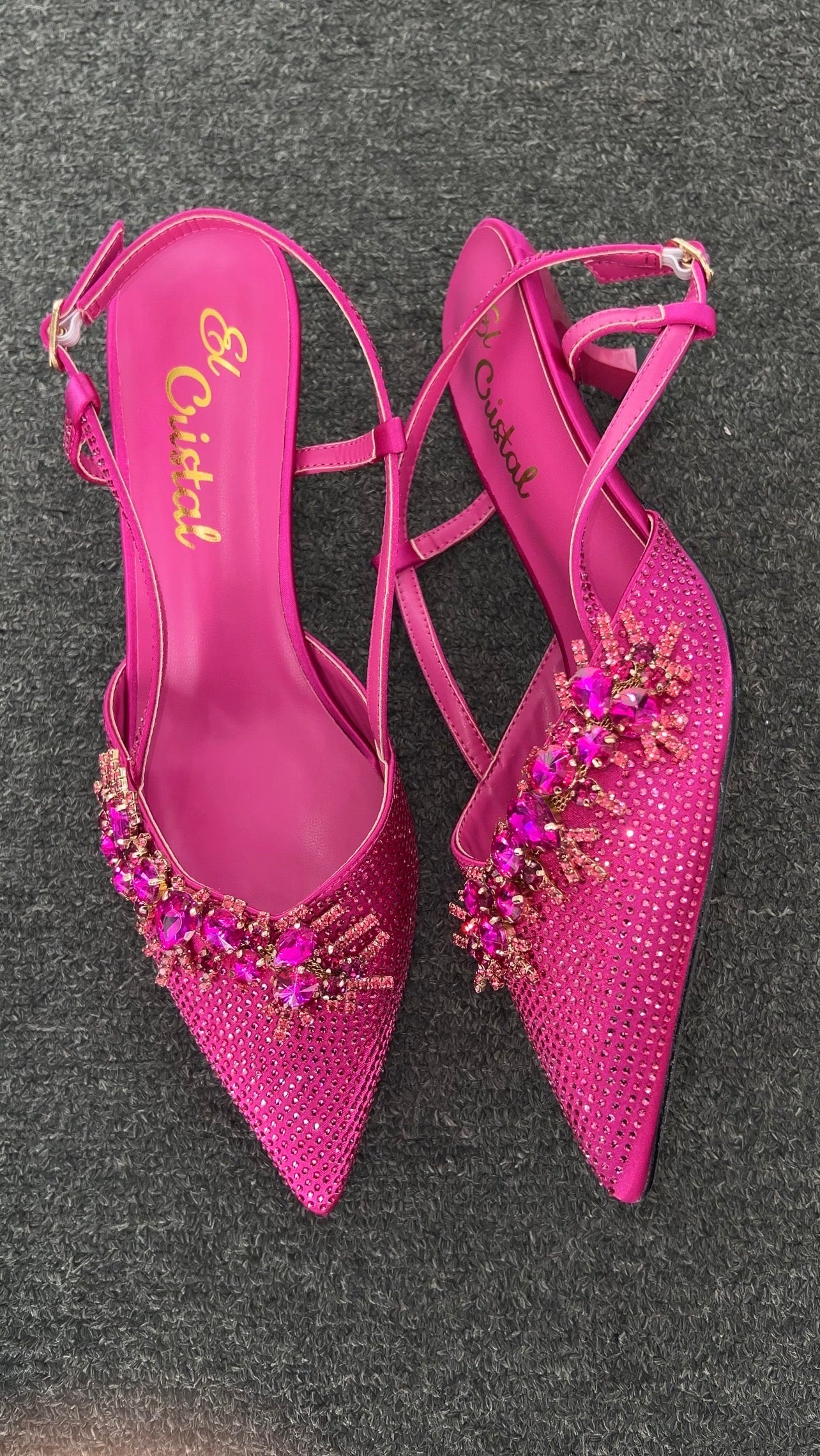 Pair of pink high-heeled shoes with embellishments . They are incredibly bold and perfect for someone who wants to make a major fashion statement.