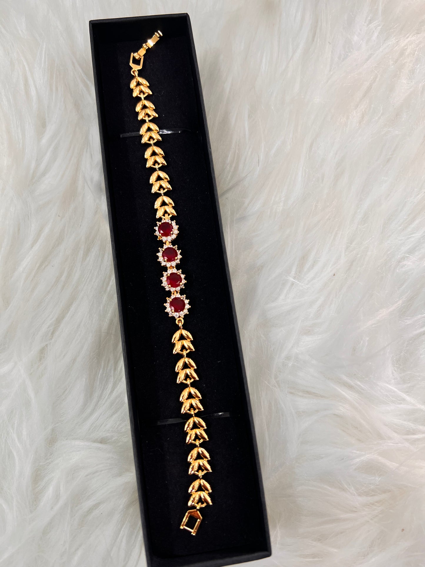 Gold bracelet with red gemstones ,This bracelet is crafted with a lightweight, flexible link structure that contours to your wrist, allowing for all-day or all-night comfort