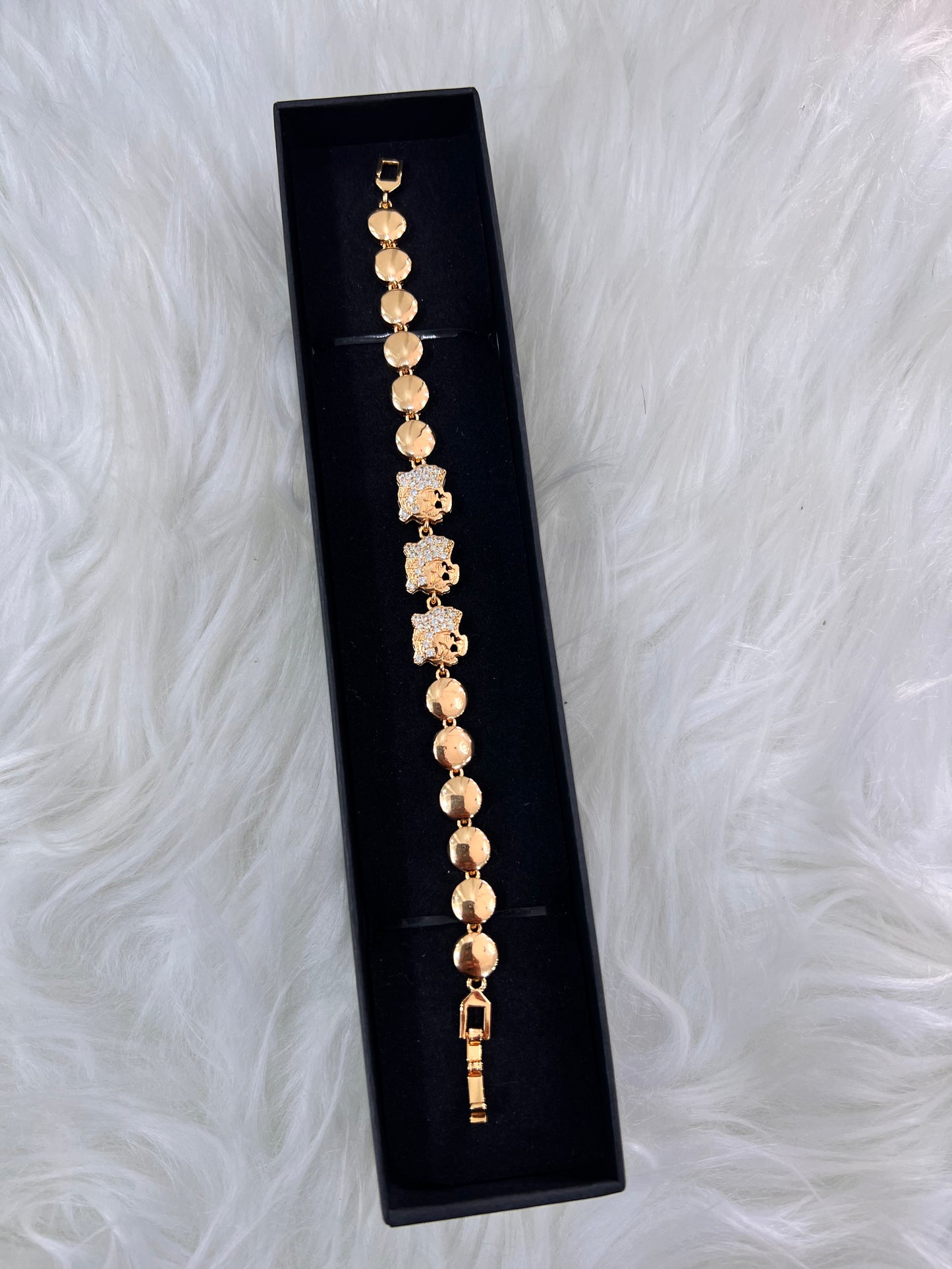 The combination of the warm gold-tone and shimmering crystals creates a high-impact accessory that elevates both evening wear and sophisticated day looks.
