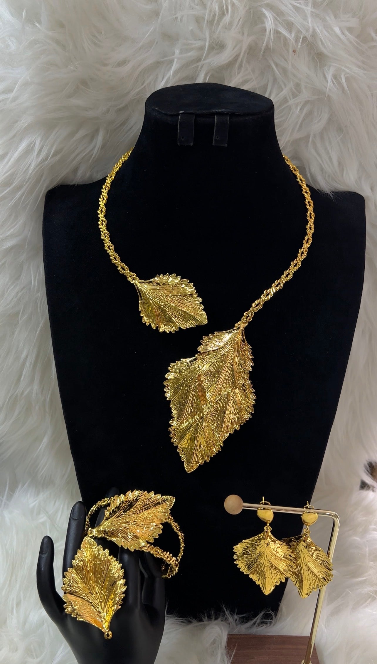 Gold leaf necklace, earrings, and ring set. Perfect for modern brides, high-fashion galas, or milestone celebrations, this set is a wearable work of art.