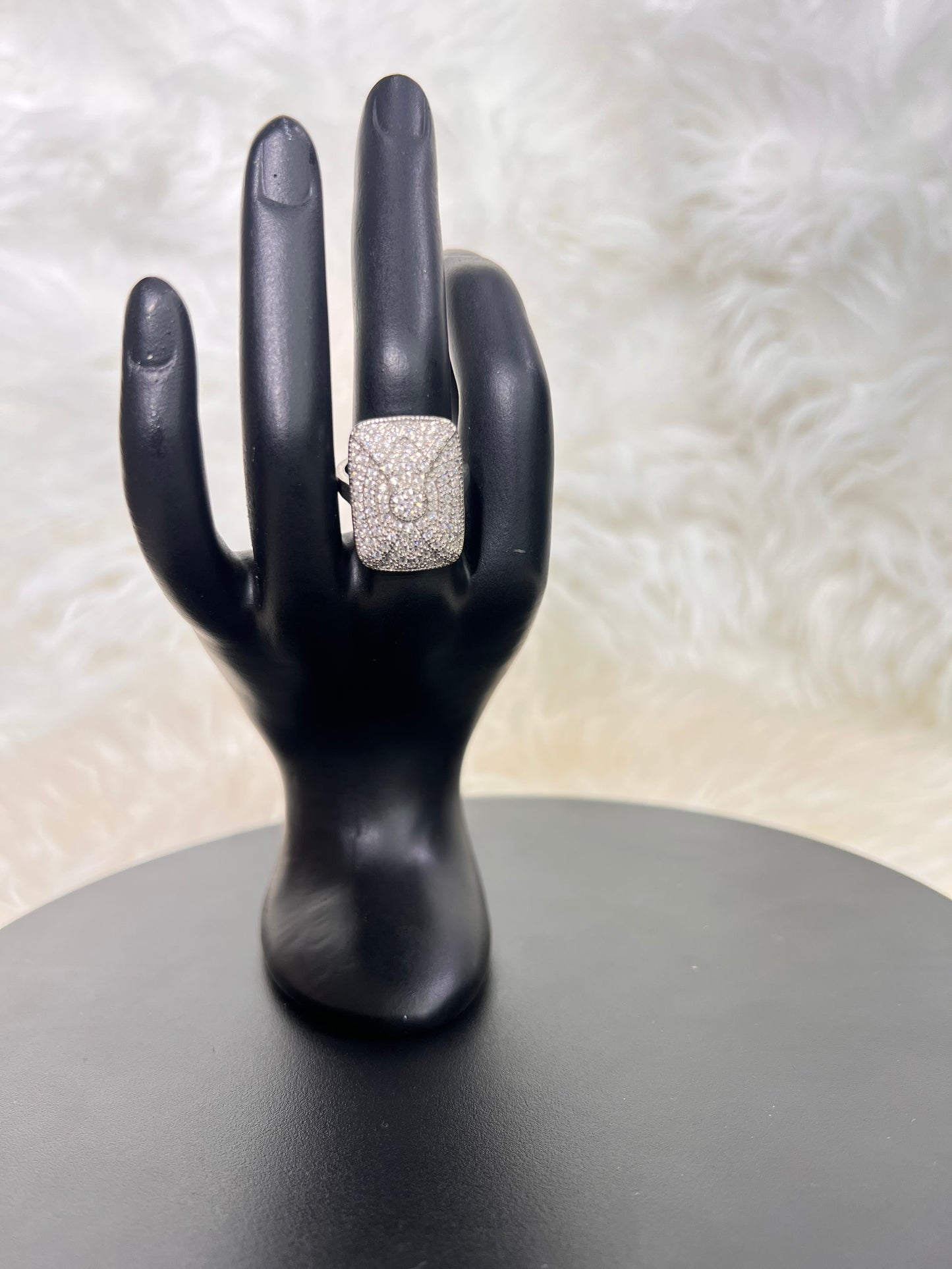 Its smooth, rounded edges and substantial knuckle-grazing presence make it the ultimate power accessory for modern bridal wear or black-tie affairs.