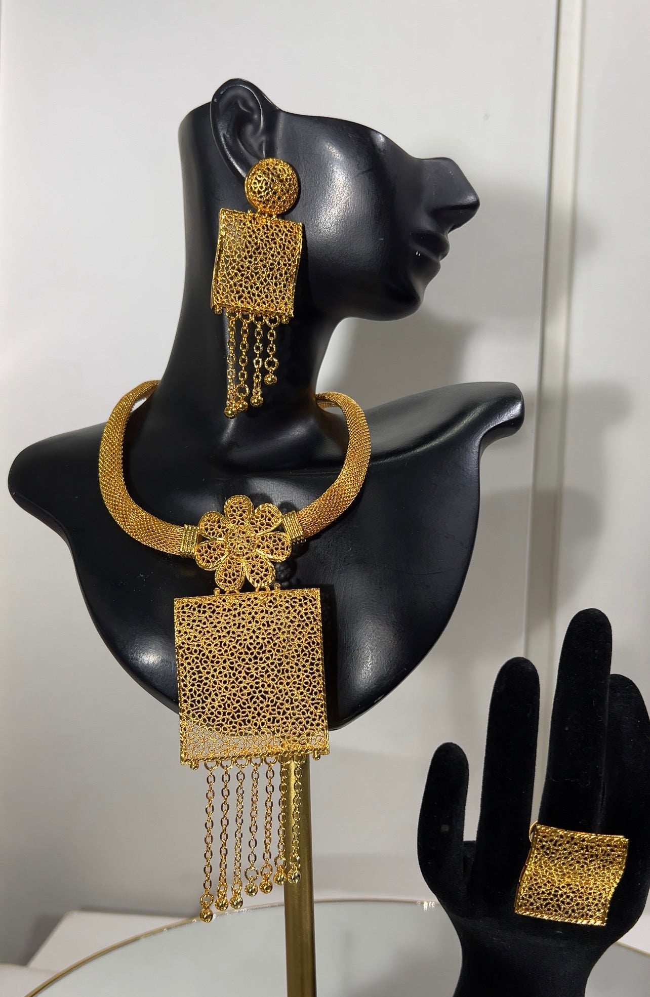 Complete with matching square statement drop earrings and an oversized square cocktail ring, this ensemble offers an elite, high-fashion aesthetic for the contemporary trendsetter.