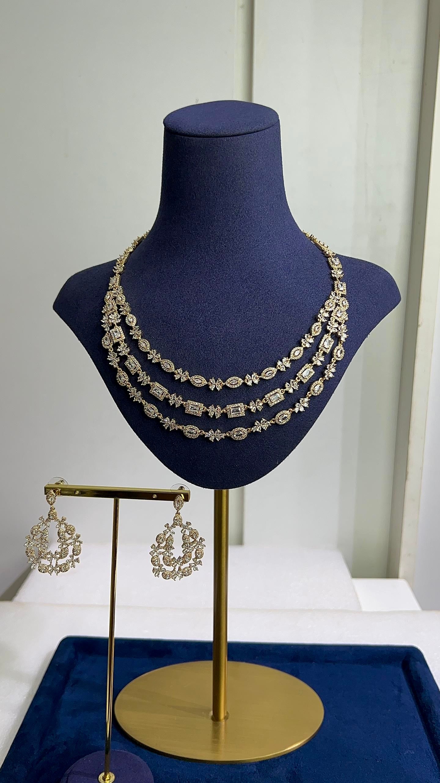 Triple layer zirconia necklace, bridal jewelry set Nigeria, chandelier earrings gold, Slim Blings luxury jewelry, layered wedding necklace, high-shine crystal jewelry set, gold-tone bridal accessories.