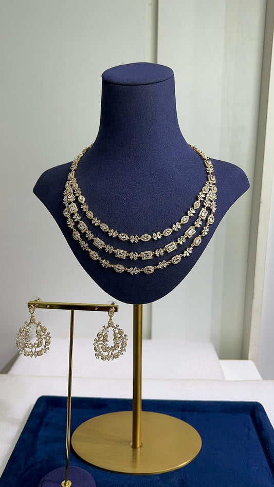 Triple layer zirconia necklace, bridal jewelry set Nigeria, chandelier earrings gold, Slim Blings luxury jewelry, layered wedding necklace, high-shine crystal jewelry set, gold-tone bridal accessories.