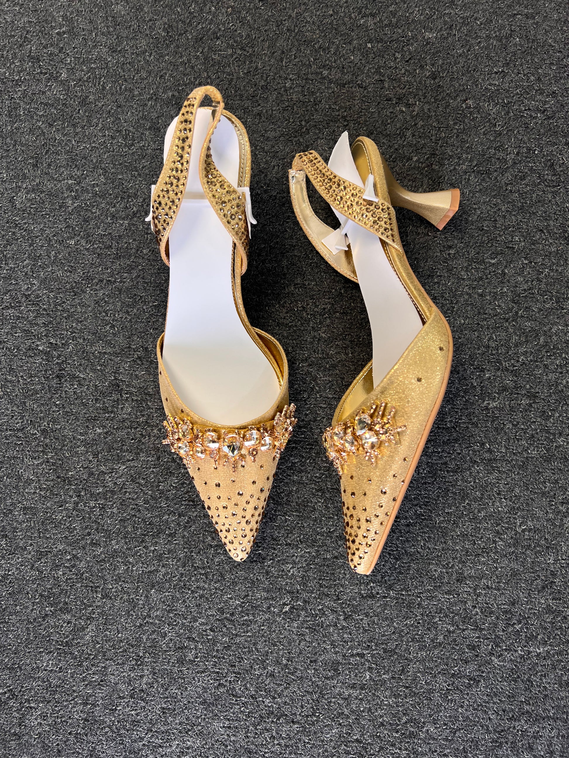 Complete with an elegant flared kitten heel and an adjustable, rhinestone-dusted slingback strap, they offer the perfect balance of show-stopping style and wearable comfort.