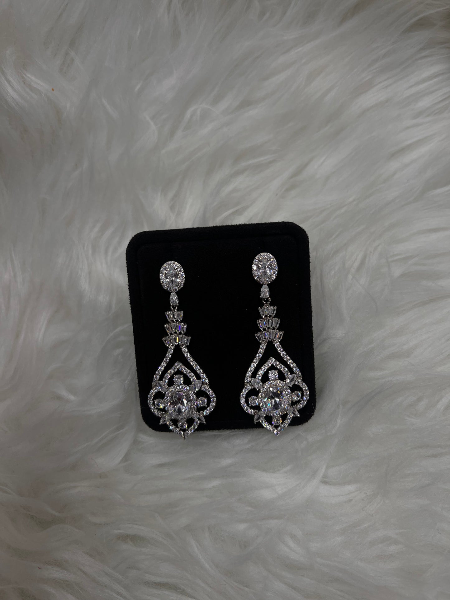 they feature a cascading design of brilliant-cut, baguette, and marquise cubic zirconia stones set in high-shine white gold-plated brass. Perfect for brides, galas, or any evening where you want to turn heads.