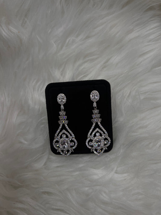 they feature a cascading design of brilliant-cut, baguette, and marquise cubic zirconia stones set in high-shine white gold-plated brass. Perfect for brides, galas, or any evening where you want to turn heads.