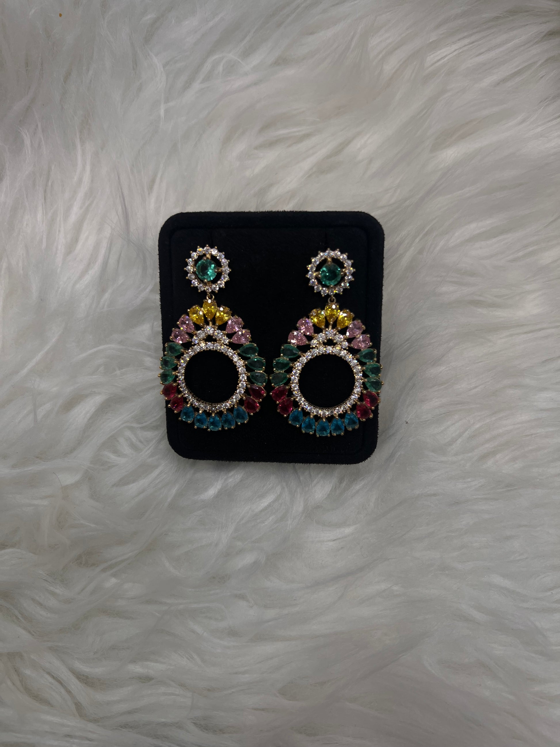 Crowned with a matching halo stud post, these earrings deliver an ultra-luxurious, playful, and glamorous touch to any neutral gown or bold party look.