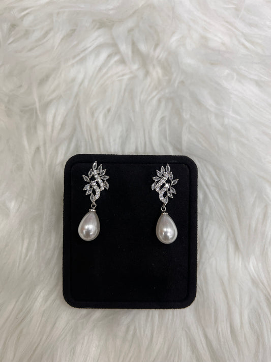 A pair of silver-toned dangle earrings with floral clusters and teardrop pearls