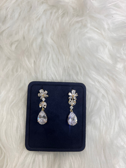 A pair of silver-tone dangle earrings with clear teardrop and floral crystals,  ideal choice for outdoor weddings, bridesmaids, or classic evening wear.