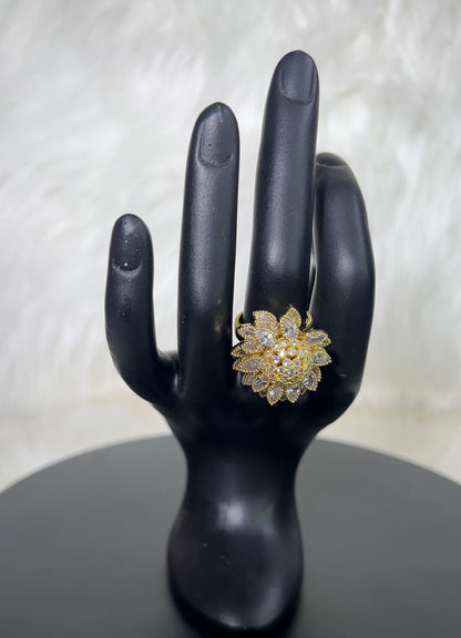 A gold flower-shaped ring with clear stones