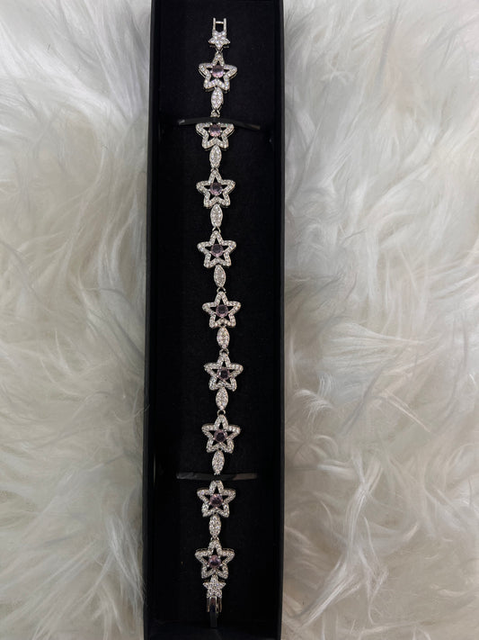 A silver-toned bracelet with repeating star motifs,