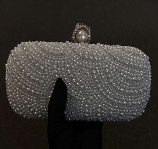  Its sleek shape is elevated by a prominent pearl top clasp, providing a refined, classic look for brides and formal guests.