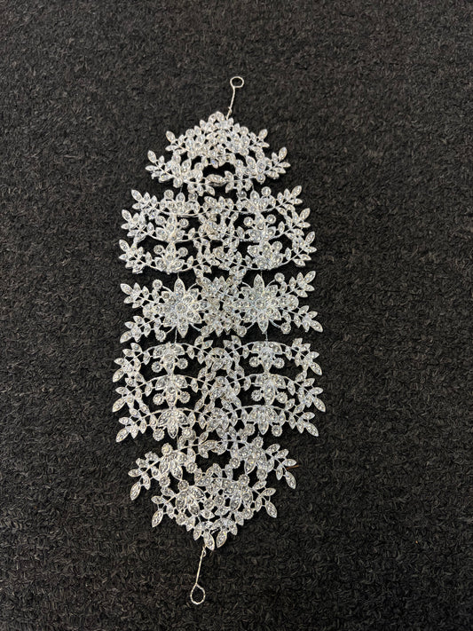 Features a rich center cluster of crystal starburst flowers flanked by detailed, lace-like leafy branches