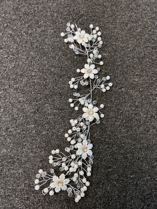 A floral hair accessory featuring white faux flowers with clear rhinestone centers and small pearl-like beads on silver-toned wire branches. Perfect for brides, bridesmaids, proms, galas, and formal evening wear.