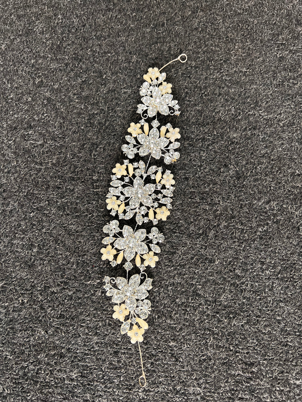 Detailed layered flower clusters and leaf sprigs designed to catch the light beautifully in wedding photos and under venue lighting.