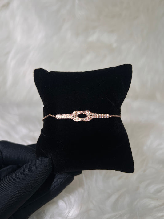 A delicate rose gold bracelet with a pavé-set bow or knot design. ideal for self-gifting, bridesmaid presents, or layering in your daily jewelry stack.