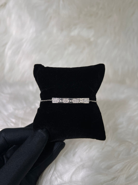 A silver-toned bar bracelet with clear stones. perfect for stacking with a classic timepiece or adding designer-inspired sparkle to an evening look.