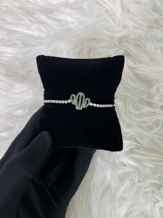Crafted in a polished silver-tone finish, it brings a refreshing splash of color and personality to evening wear or elevated daily attire.
