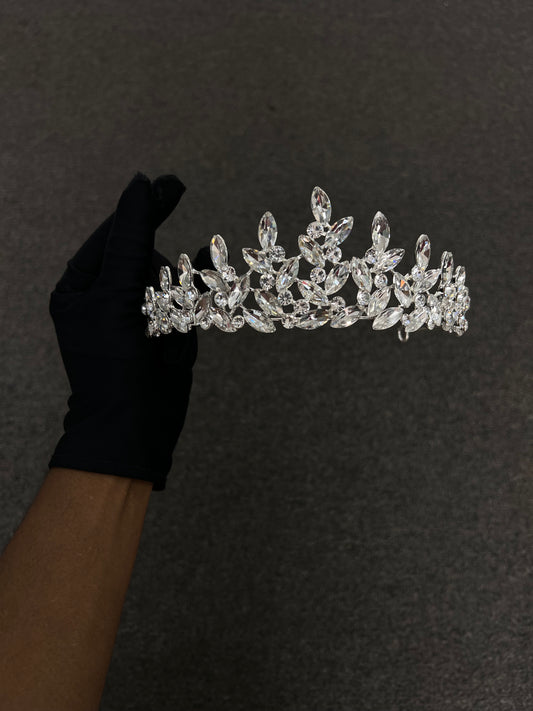 A silver-toned tiara adorned with clear marquise and oval-cut crystals, 

Best For: Bohemian brides, outdoor or destination weddings, half-up hairstyles, and sleek evening wear.