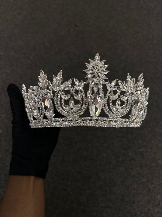 A sparkling silver tiara adorned with clear crystals and ornate scrollwork, Perfect Glamorous evening galas, pageants, and  bridal entrances.