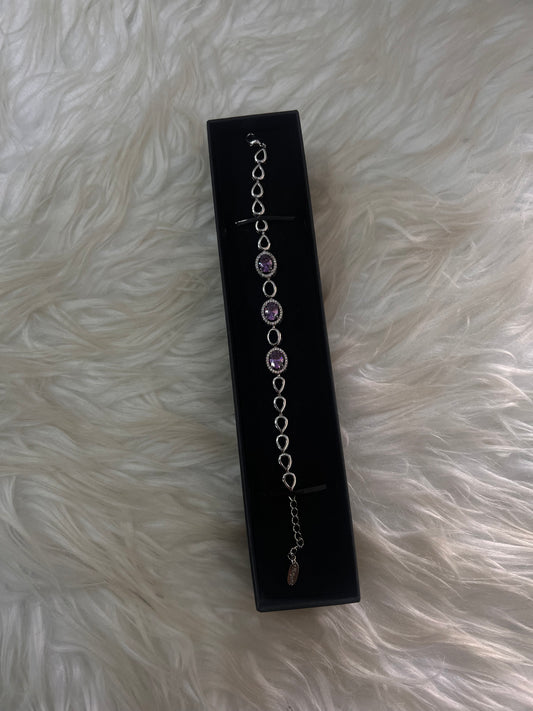  Complete with an extender chain for an adjustable fit, this versatile piece adds a refined touch of royal color to both evening wear and formal attire.