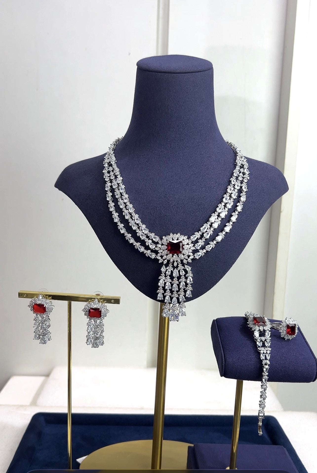 Jewelry set including necklace, earrings, and bracelet on a mannequin bust with a white background.