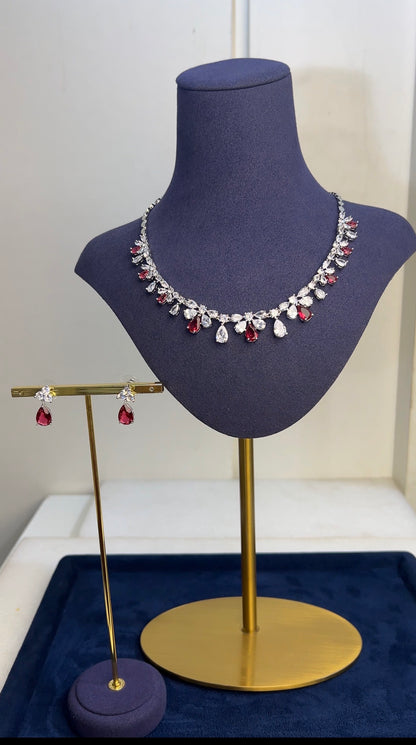 Necklace and earrings on a mannequin bust with a white background