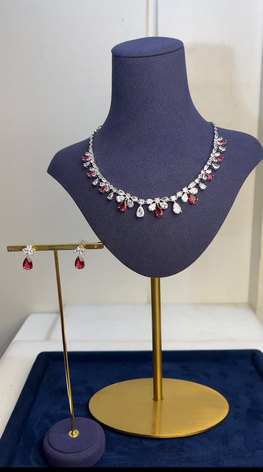 Necklace and earrings on a mannequin bust with a white background