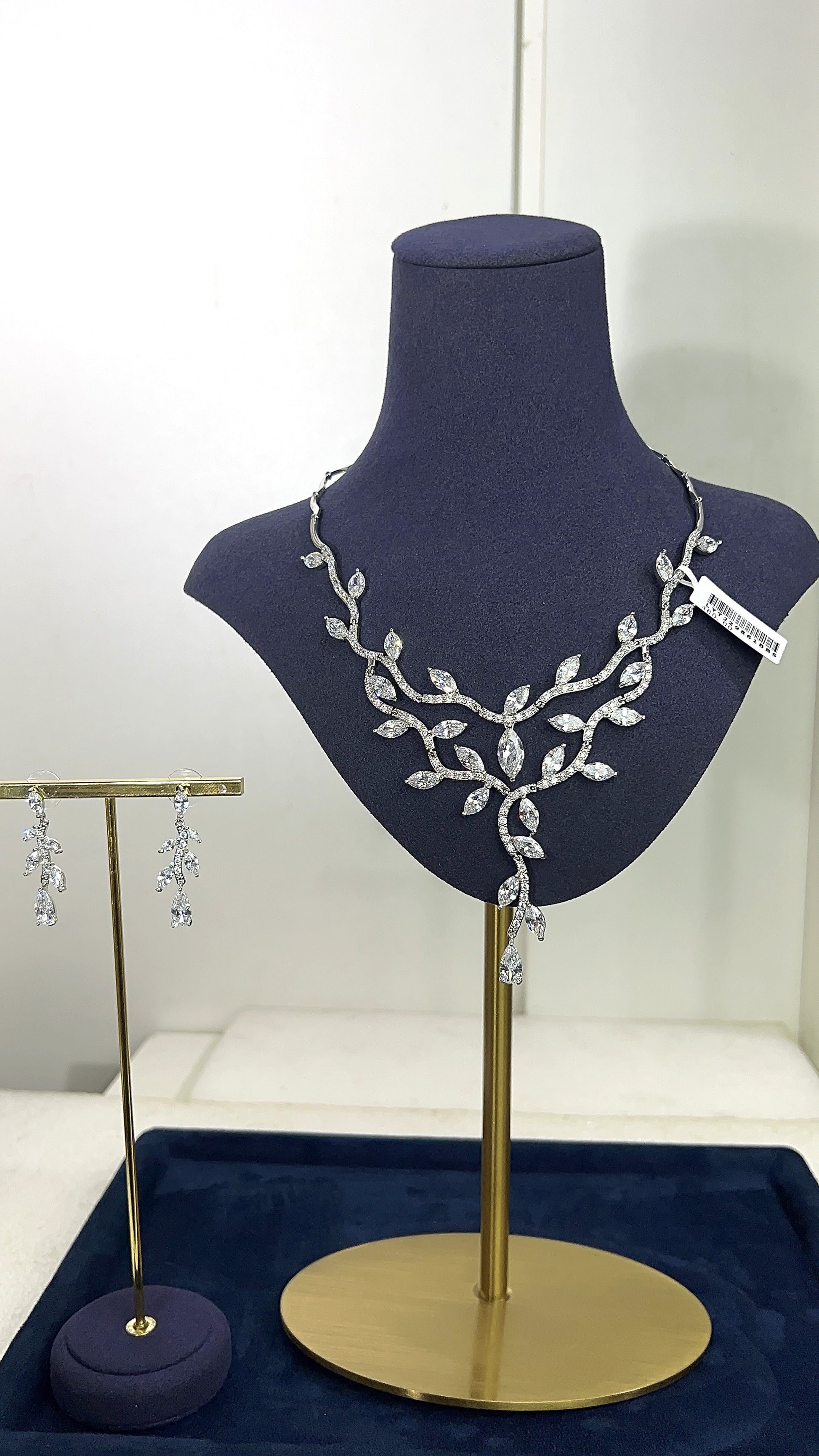 Jewelry set on a mannequin bust with a white background