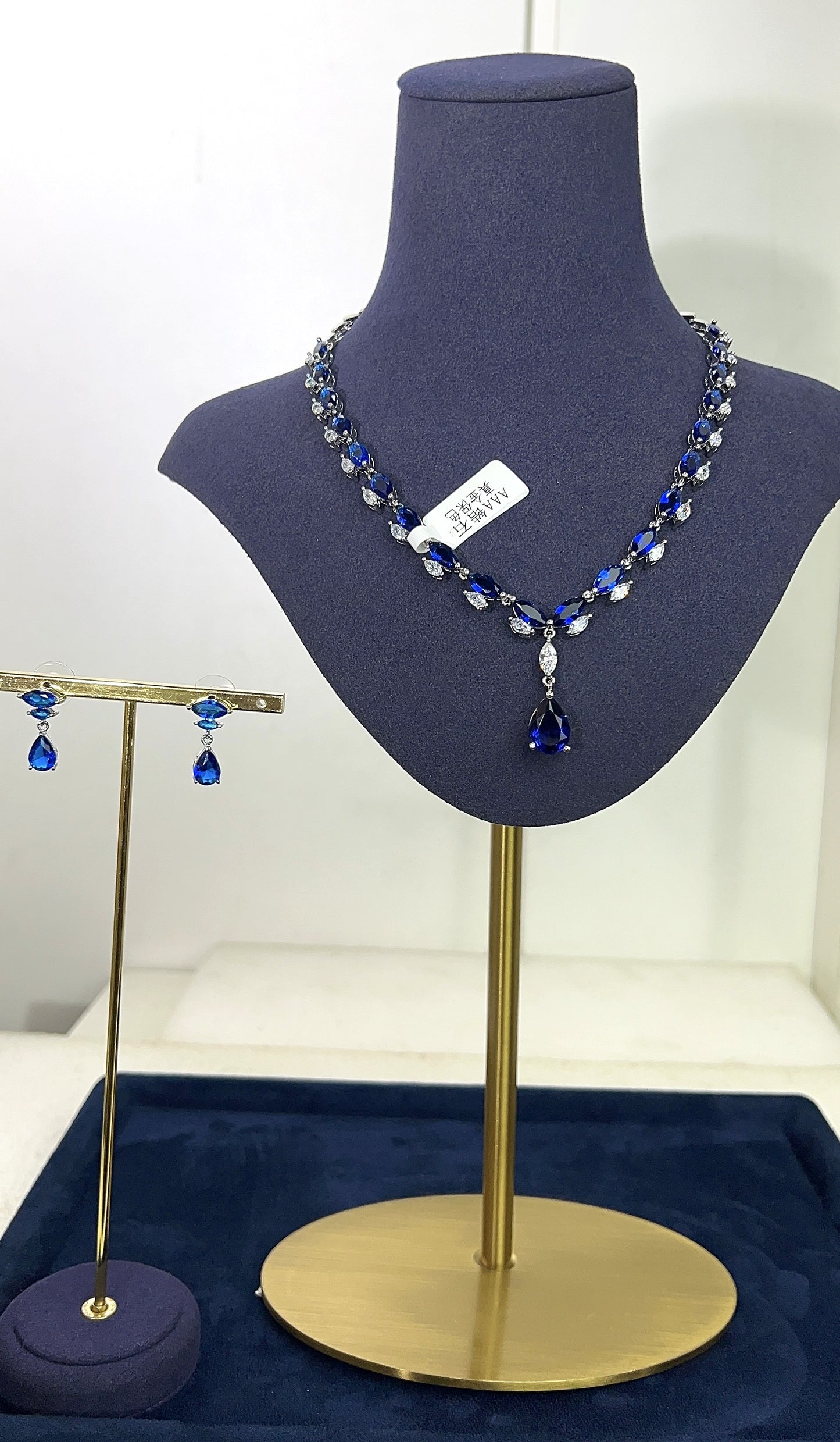 Necklace on a mannequin bust with a blue background