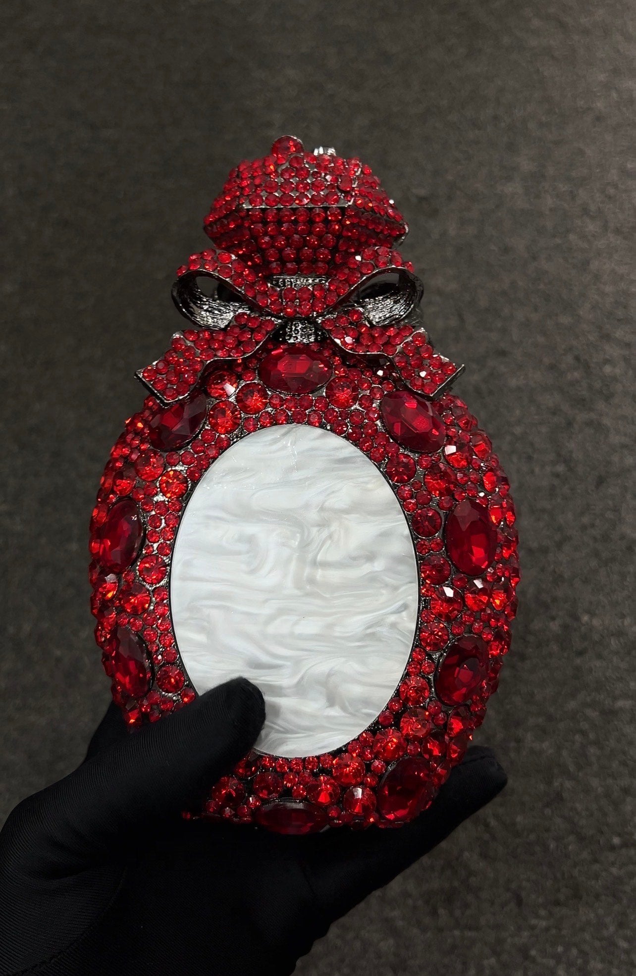 Decorative Clutch with gemstones and a central white oval 