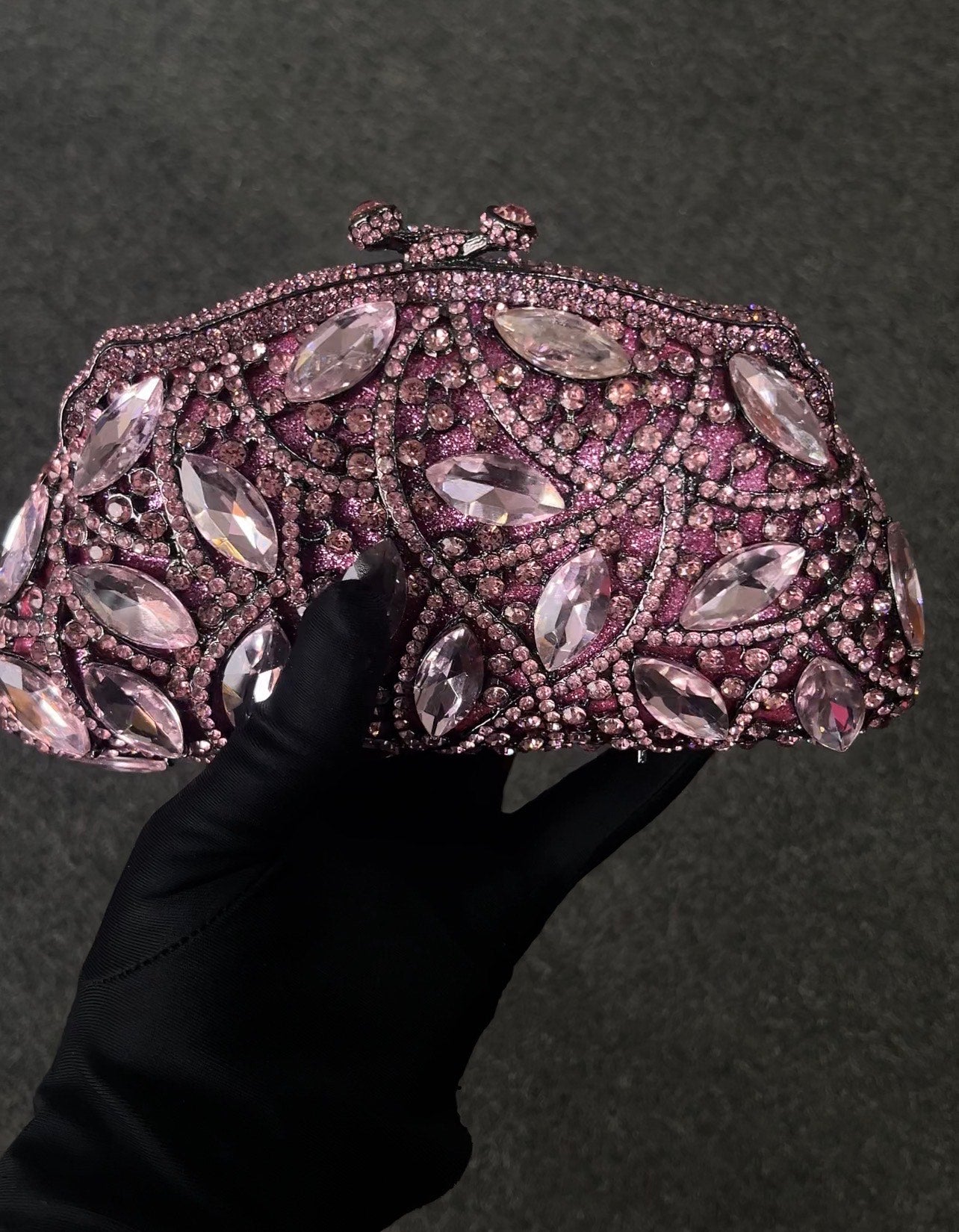 Decorative clutch bag with gemstone-like embellishments 