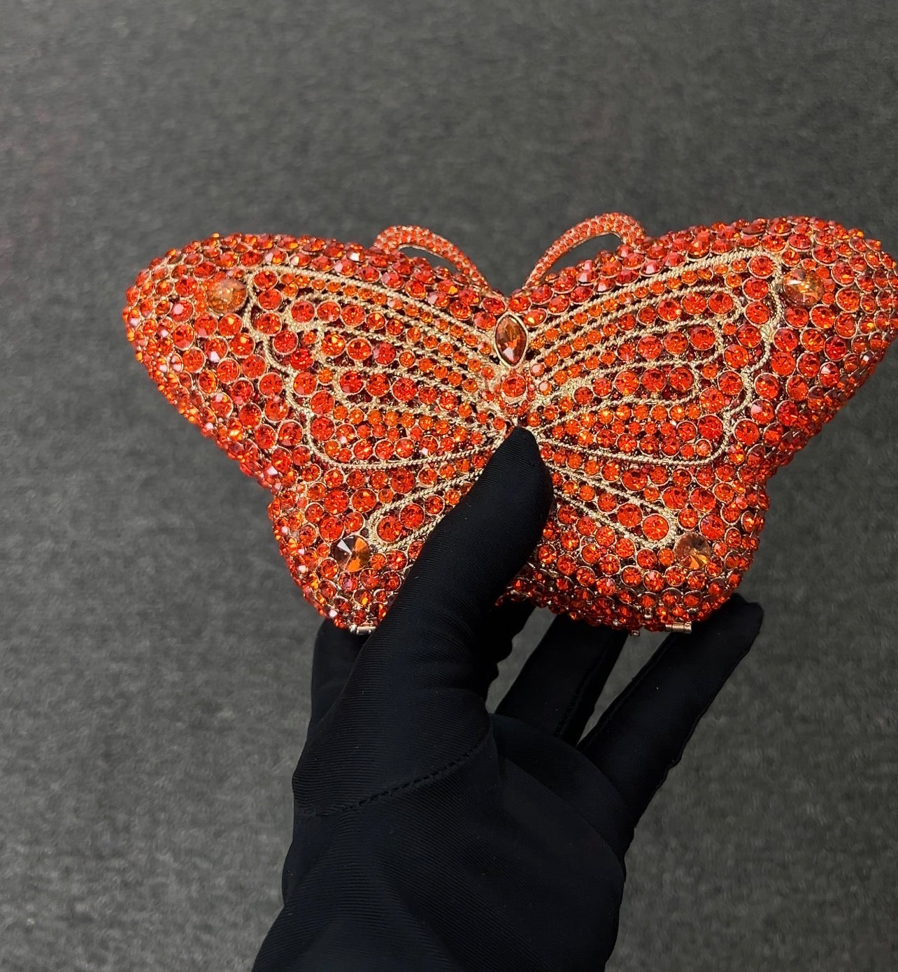 Butterfly-shaped clutch offering a glamorous, nature-inspired statement with an elegant iced finish.