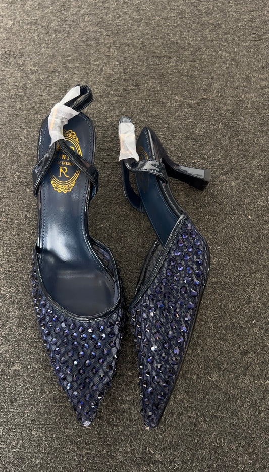 High-heeled shoes with sequin details on Featuring a contemporary sheer mesh upper, these heels are meticulously embellished with a grid of tonal navy studs that offer a subtle, sophisticated shimmer