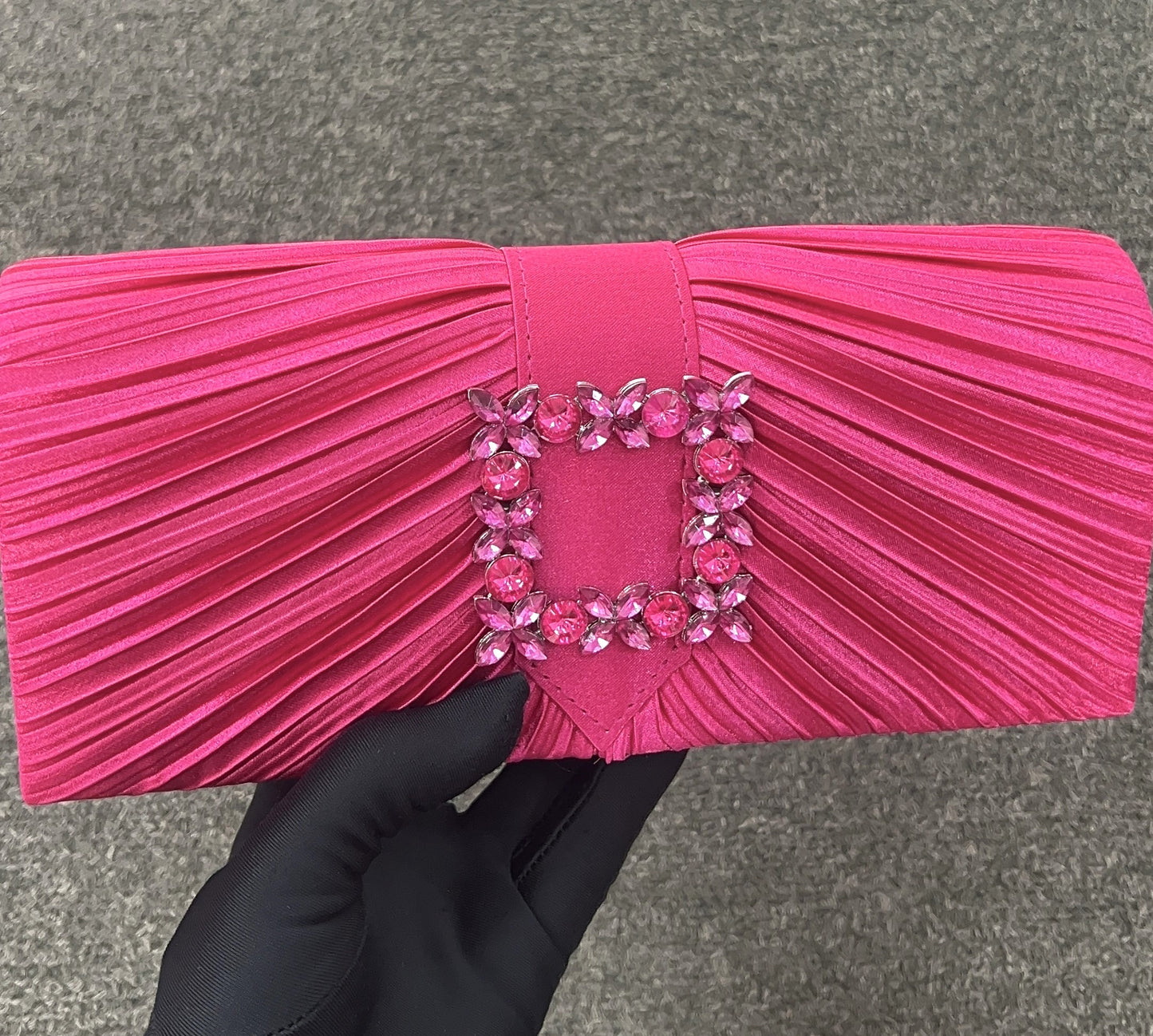Pleated clutch with gemstone embellishments Designed as a sleek handheld clutch, with the option to attach a chain (included) for effortless shoulder-carry transition