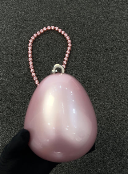 The smooth, luminous surface catches the light with subtle, multi-colored shimmers, ensuring you glow from every angle