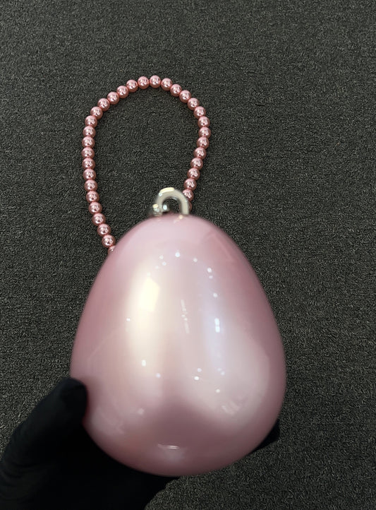 The smooth, luminous surface catches the light with subtle, multi-colored shimmers, ensuring you glow from every angle