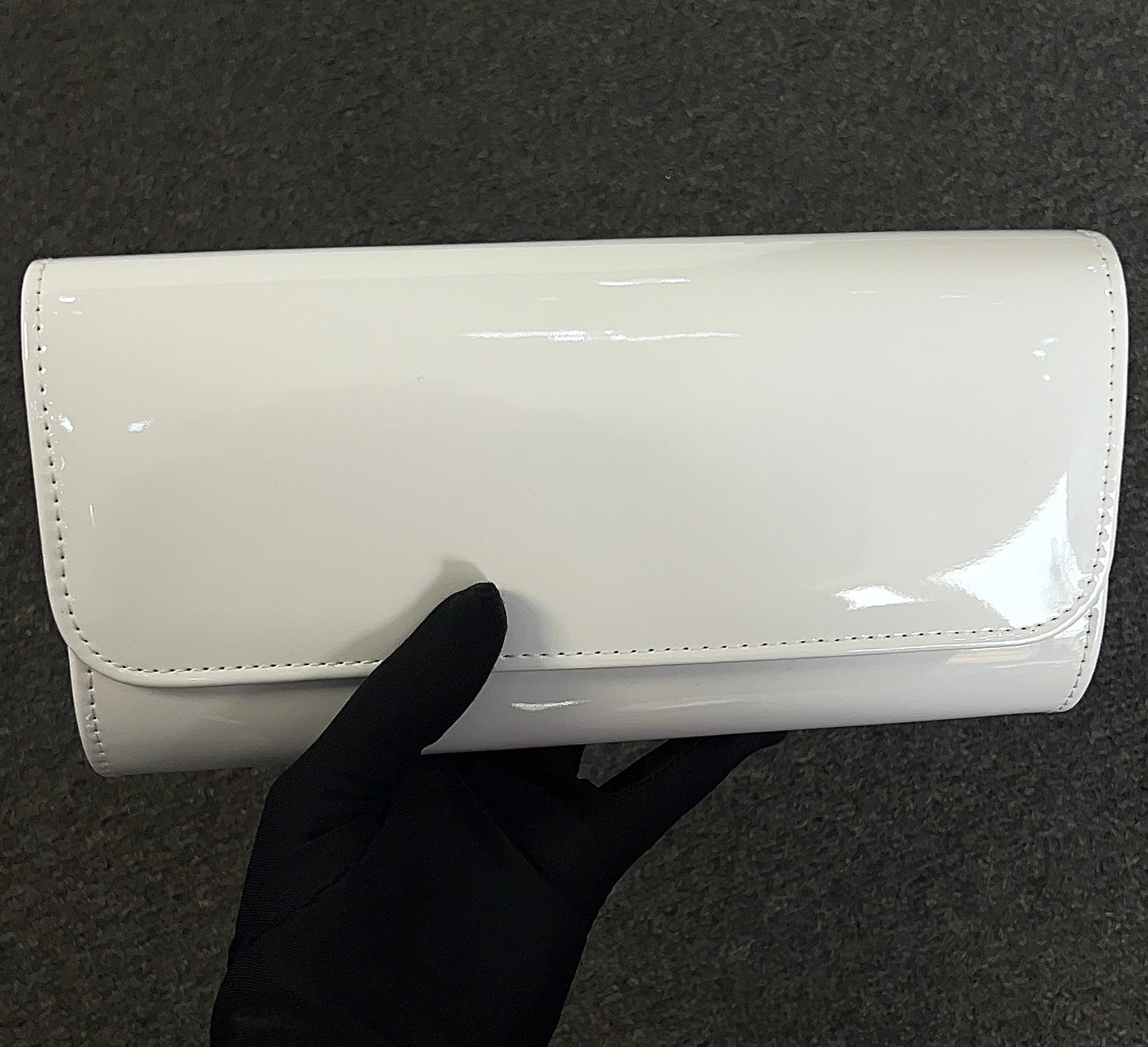 The patent material is durable and easy to wipe clean, keeping your accessory looking fresh event after event.