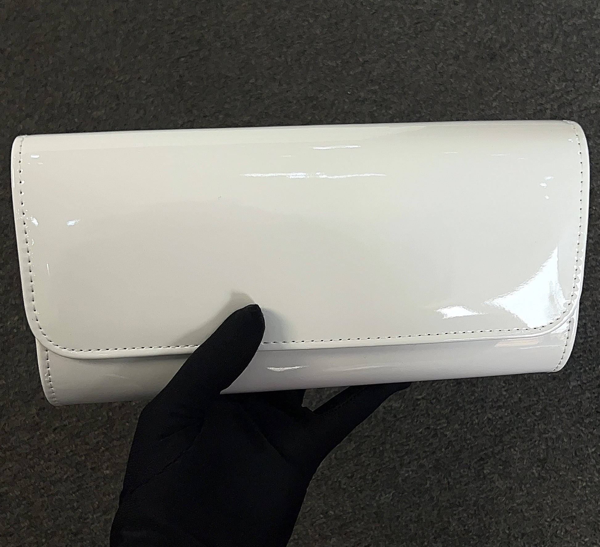 The patent material is durable and easy to wipe clean, keeping your accessory looking fresh event after event.