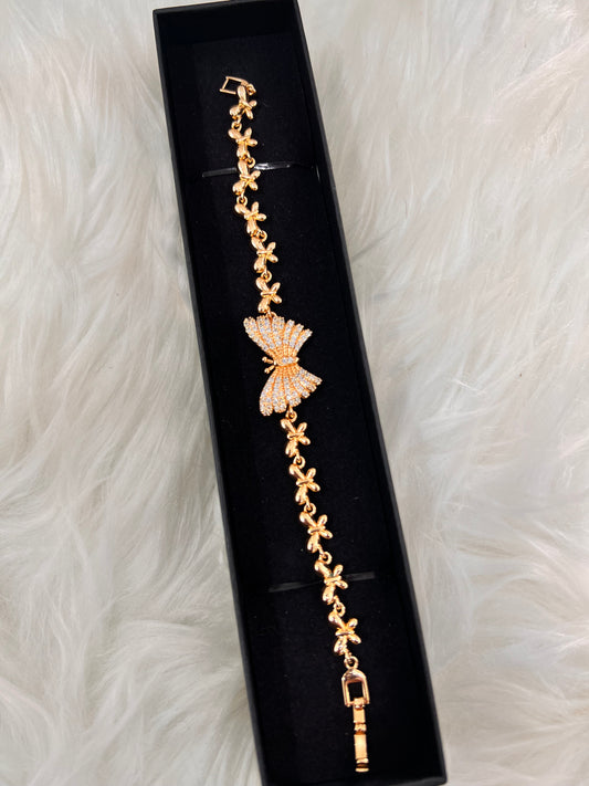 The gold tone and sparkling crystals make it an ideal companion for warm-toned