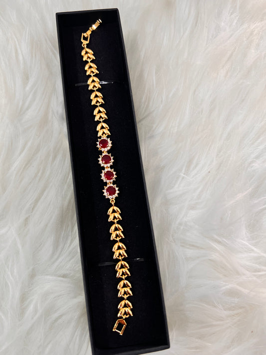 Gold bracelet with red gemstones ,This bracelet is crafted with a lightweight, flexible link structure that contours to your wrist, allowing for all-day or all-night comfort