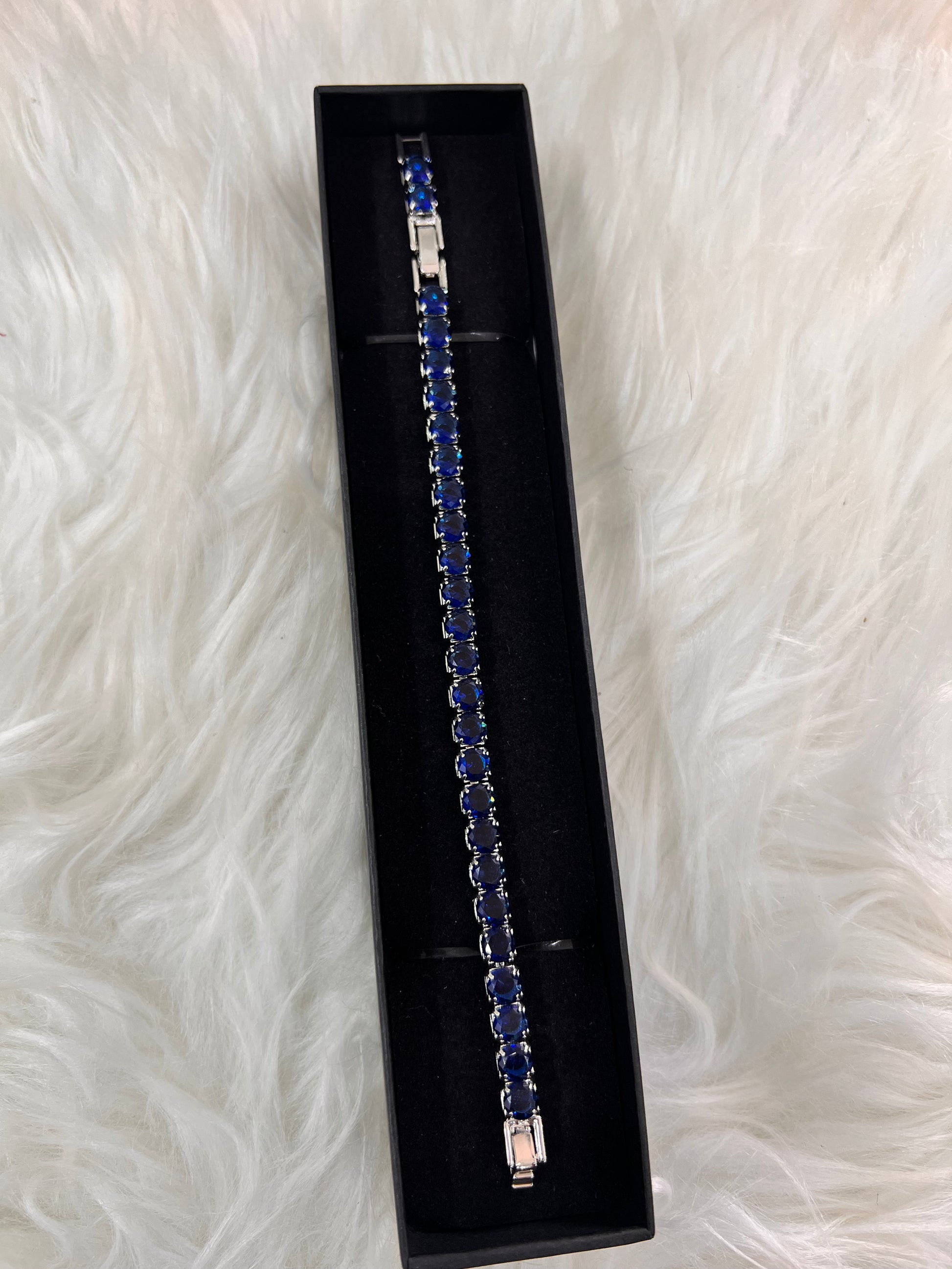 Silver bracelet with blue stones The dark, light-absorbing stones offer a sharp contrast to traditional jewelry.