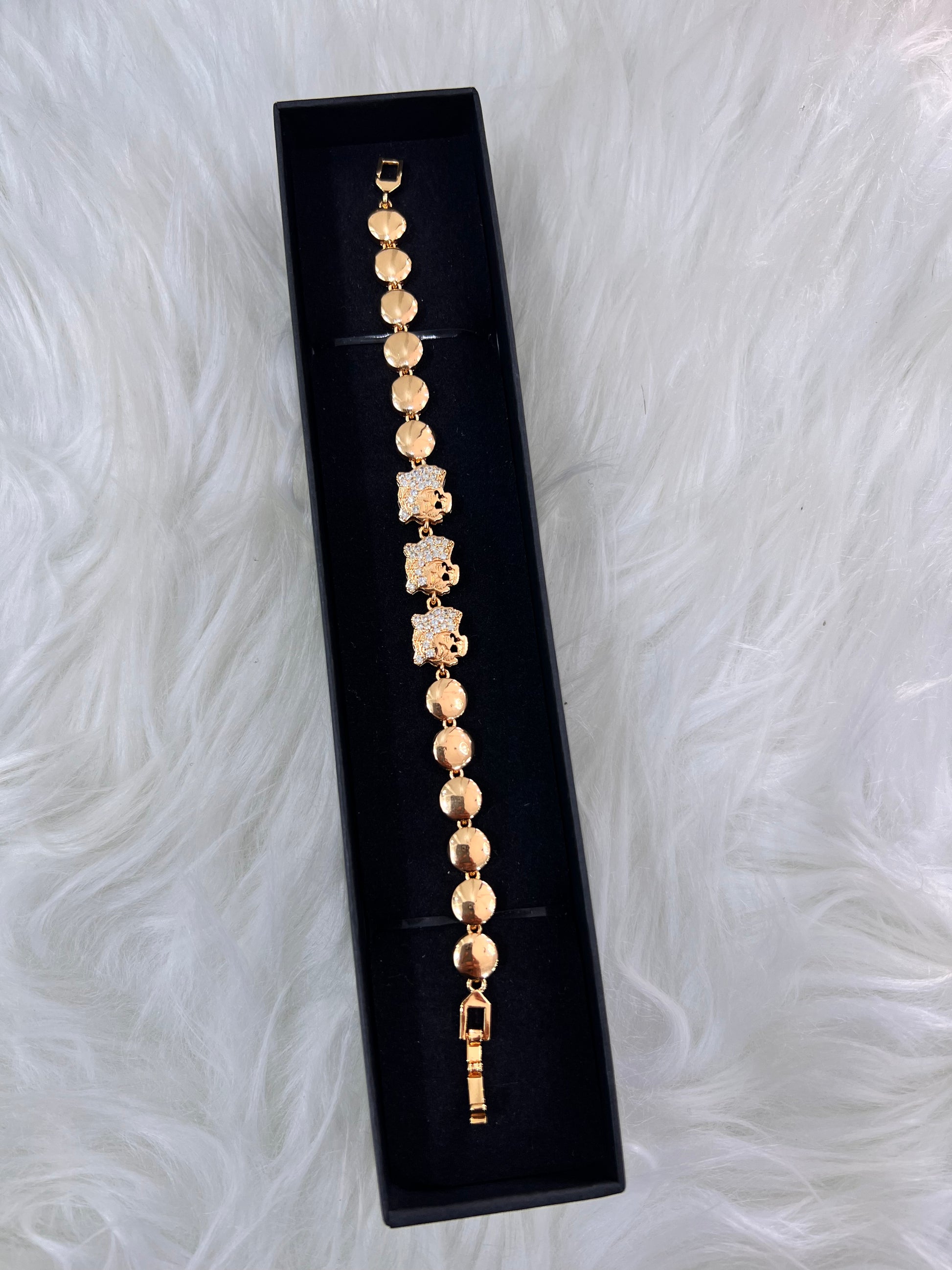 The combination of the warm gold-tone and shimmering crystals creates a high-impact accessory that elevates both evening wear and sophisticated day looks.
