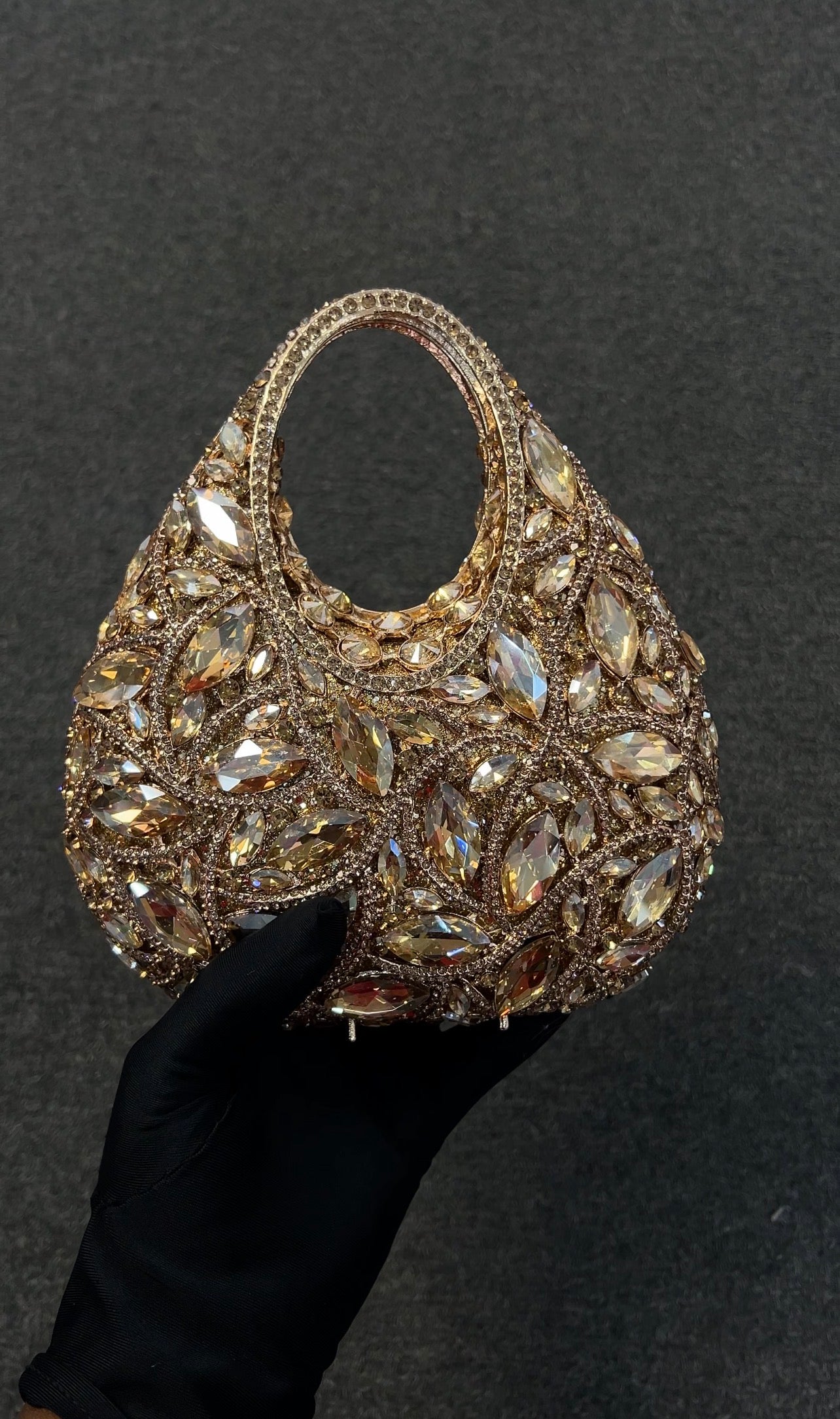 Elegant handbag with intricate gemstone detailing. It is a high-fashion accessory designed for individuals attending black-tie galas, red carpet events, or high-society parties.