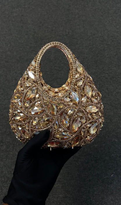 Elegant handbag with intricate gemstone detailing. It is a high-fashion accessory designed for individuals attending black-tie galas, red carpet events, or high-society parties.