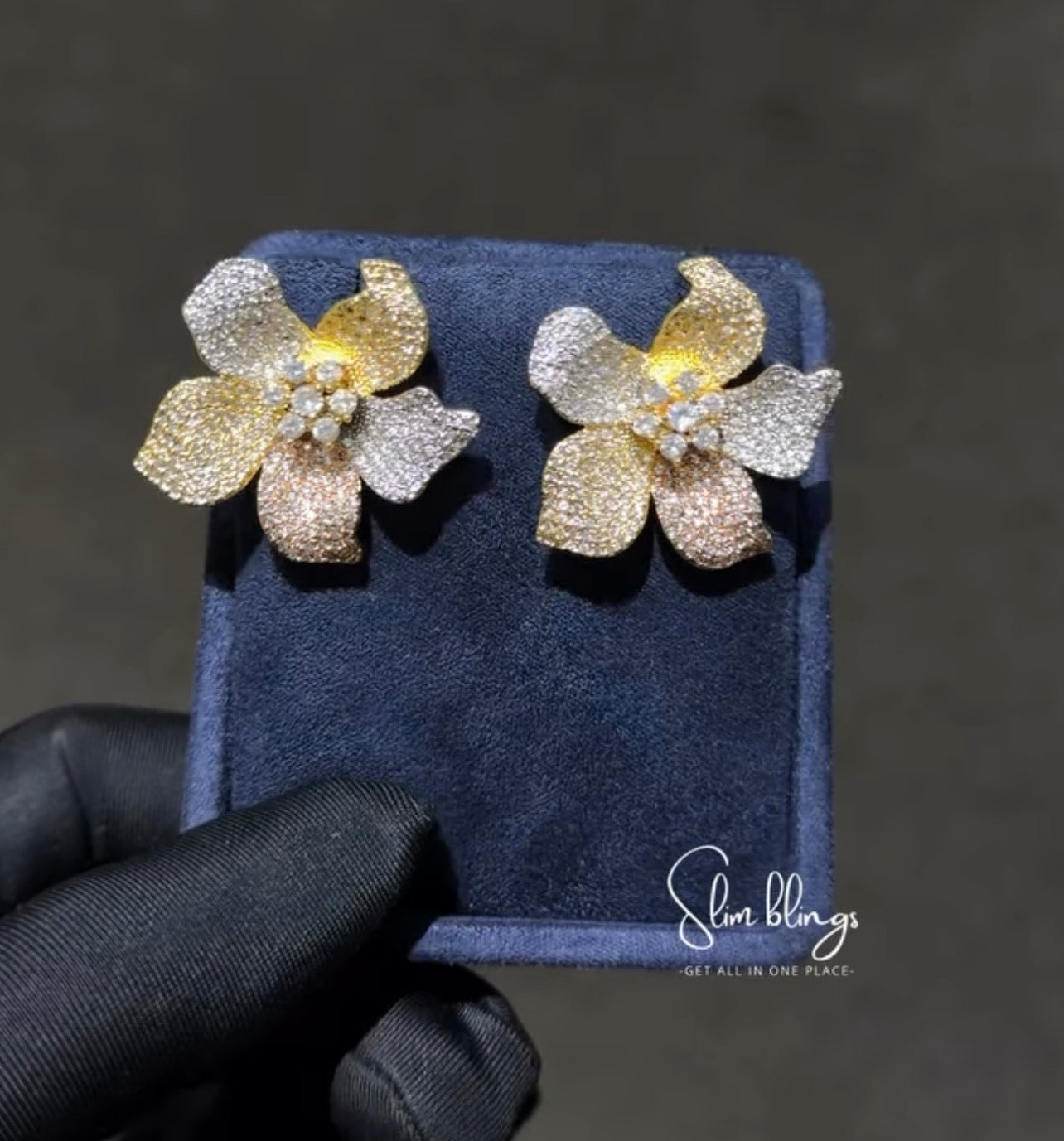 Pair of gold and silver flower-shaped earrings 