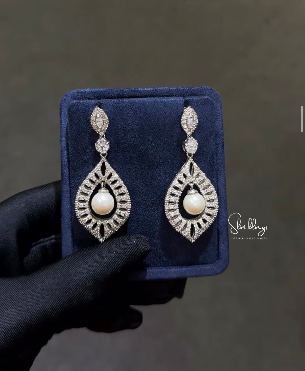 Featuring a crystal-paved Moroccan shield design with a suspended centerpiece pearl. Perfect for brides and formal wear.