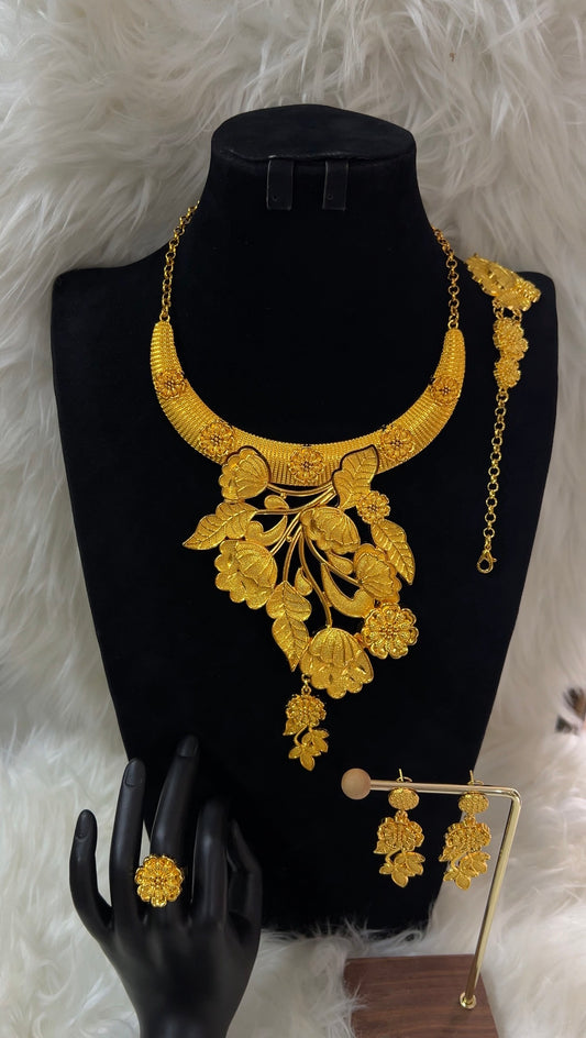 Complete with sharp geometric drop earrings, a matching shield ring, and a coordinated link bracelet, this set radiates unparalleled prestige, wealth, and tradition.